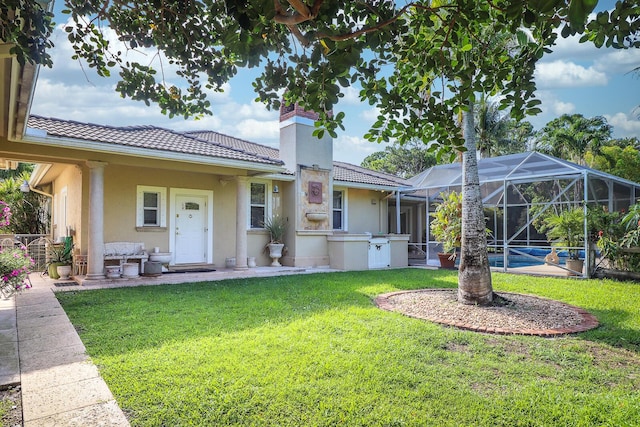 view of front of property featuring a pool, a front lawn, and a lanai