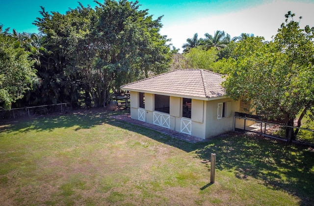 view of side of home featuring a lawn