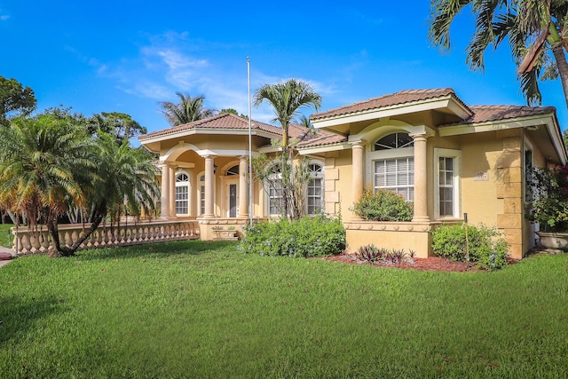 mediterranean / spanish home featuring a front yard