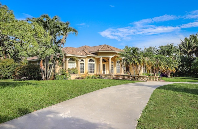 mediterranean / spanish home featuring a front yard