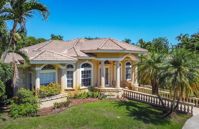 mediterranean / spanish-style house with a front lawn