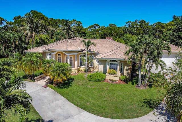 mediterranean / spanish house with a front yard