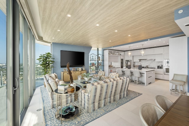 living room featuring floor to ceiling windows and wooden ceiling