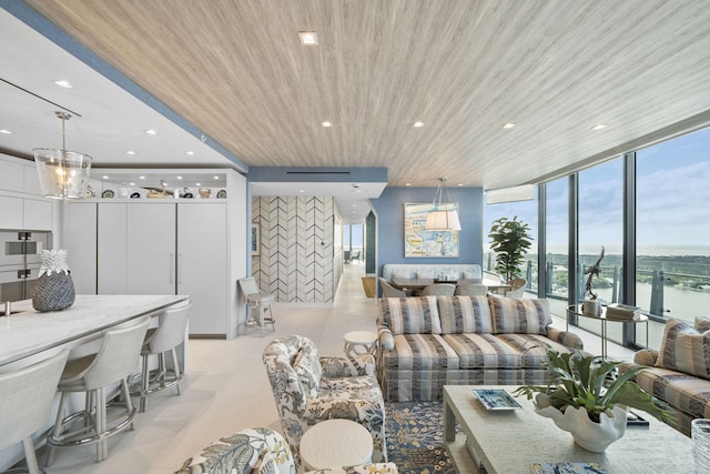 living room featuring a wall mounted air conditioner, a water view, a wall of windows, and wood ceiling