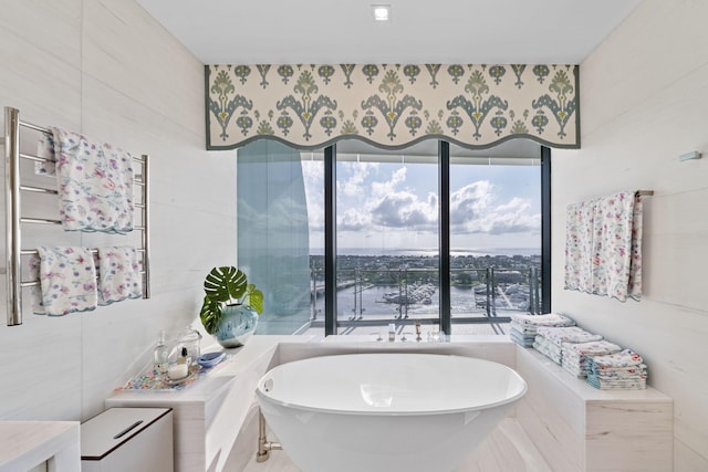 bathroom featuring tile walls and a tub