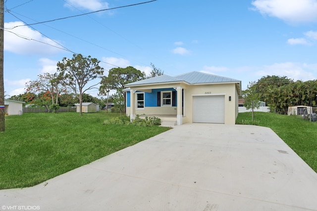 view of front of property with a garage and a front yard