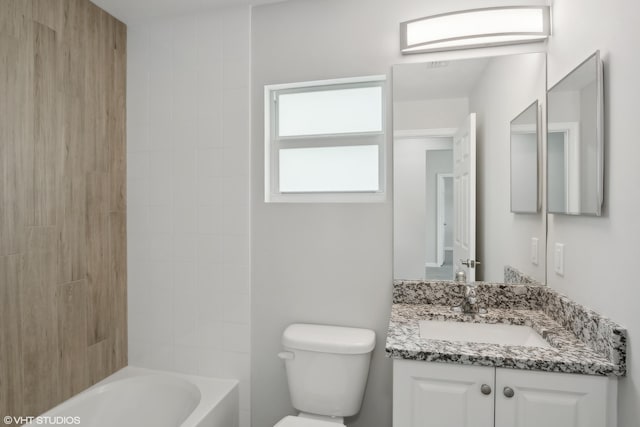 full bathroom featuring vanity, tiled shower / bath combo, and toilet