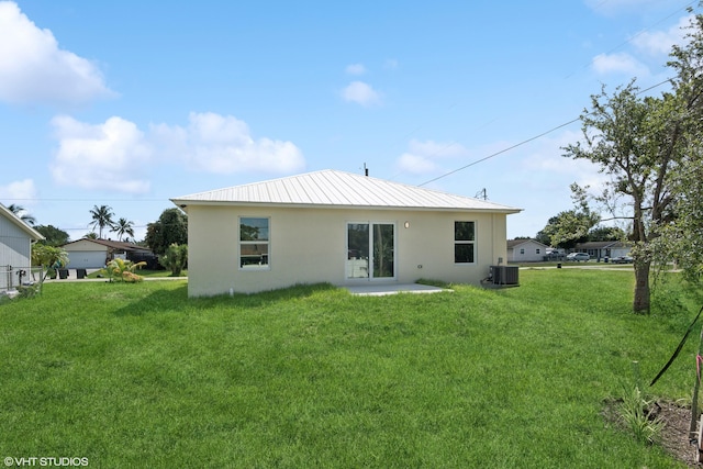 back of property with a lawn, central AC, and a patio