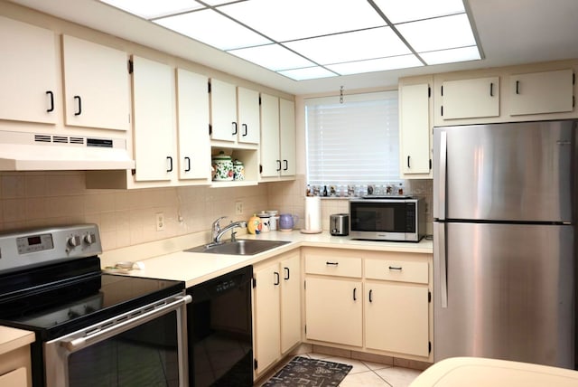 kitchen with light tile patterned flooring, premium range hood, tasteful backsplash, stainless steel appliances, and sink