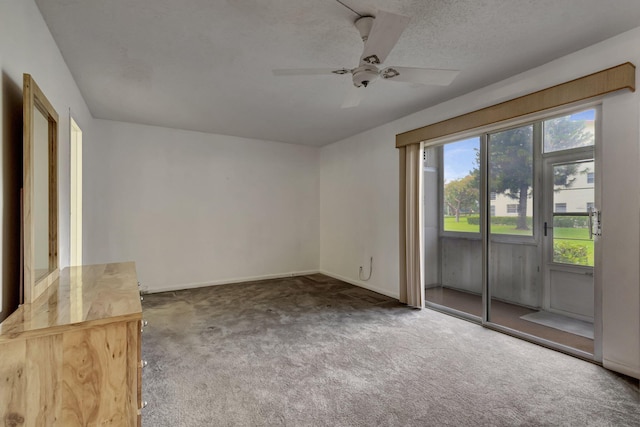 carpeted empty room featuring a textured ceiling and ceiling fan