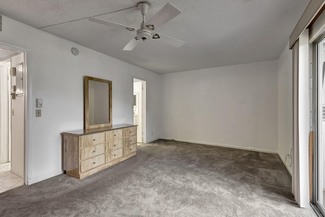 unfurnished bedroom featuring ceiling fan and carpet floors