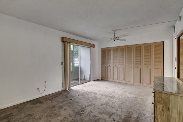 interior space featuring carpet, a textured ceiling, and ceiling fan