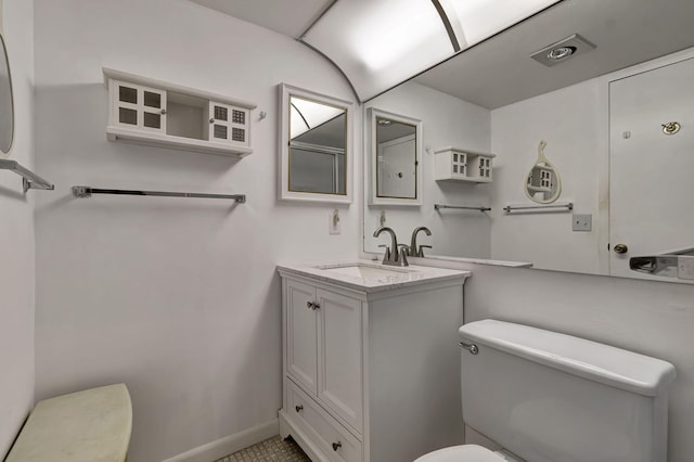 bathroom with tile patterned floors, vanity, and toilet