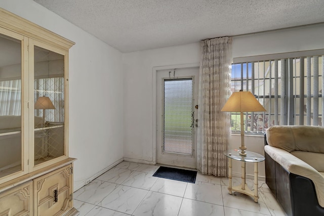 doorway featuring a textured ceiling