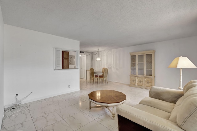 living room featuring a textured ceiling and a chandelier