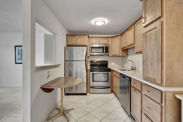 kitchen with sink, stainless steel appliances, and light brown cabinets