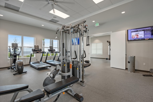 workout area featuring ceiling fan and a drop ceiling