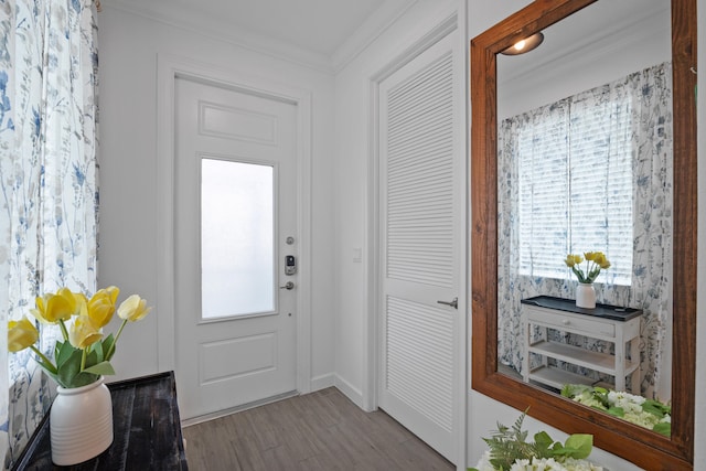 entrance foyer with a wealth of natural light, hardwood / wood-style floors, and ornamental molding