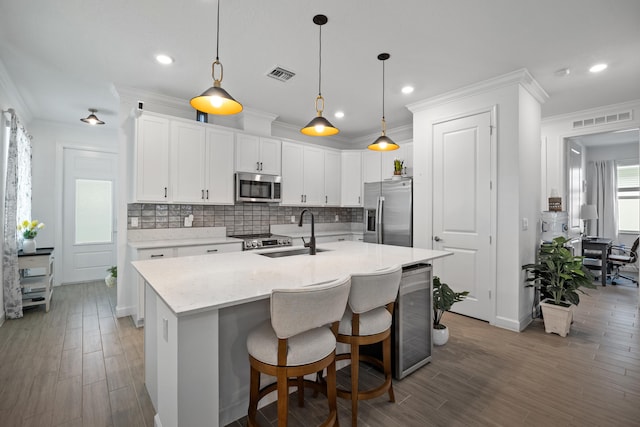 kitchen featuring white cabinetry, sink, a healthy amount of sunlight, and appliances with stainless steel finishes