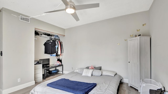 bedroom featuring a closet, ceiling fan, and light hardwood / wood-style flooring