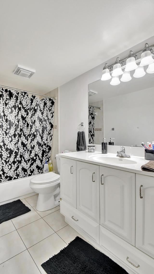 bathroom with tile patterned flooring, vanity, and toilet