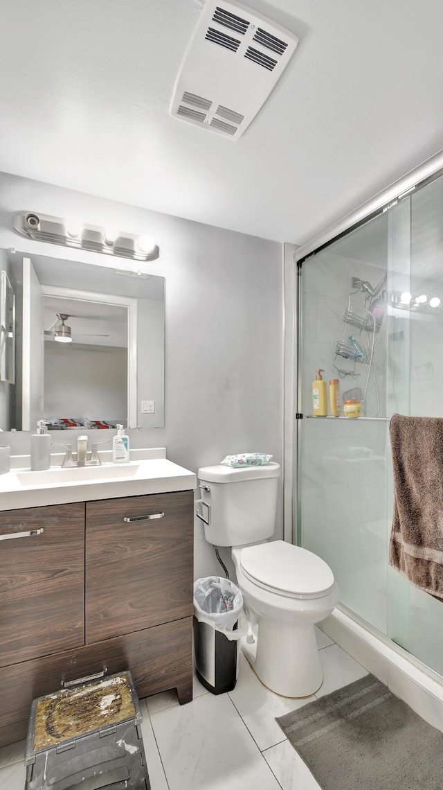 bathroom with vanity, toilet, and a shower with shower door