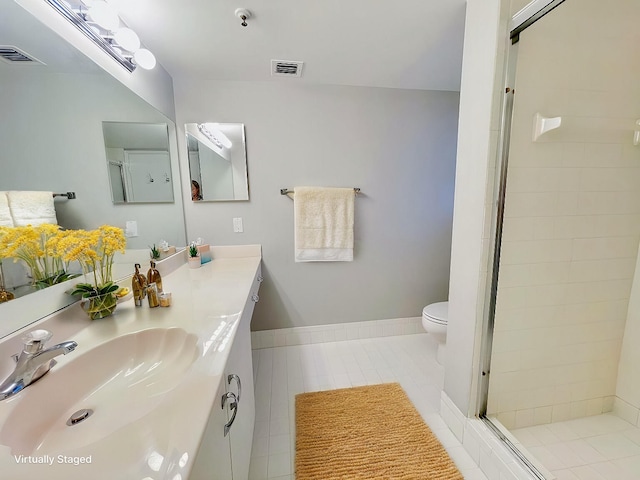 bathroom featuring toilet, tile patterned flooring, vanity, and walk in shower