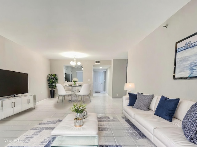 tiled living room with an inviting chandelier