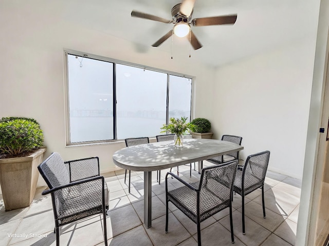 tiled dining space with a wealth of natural light and ceiling fan