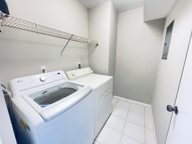 laundry room with washing machine and dryer and light tile patterned flooring