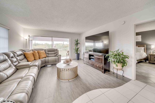 tiled living room featuring a textured ceiling