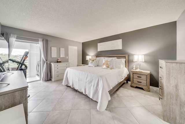 bedroom with access to outside, a textured ceiling, and light tile flooring