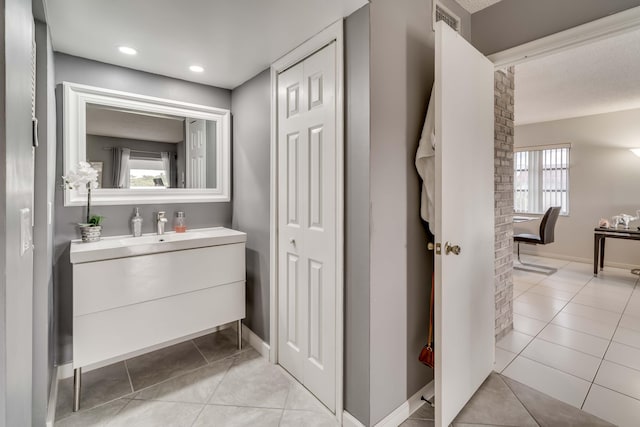 bathroom featuring tile flooring, a healthy amount of sunlight, and large vanity