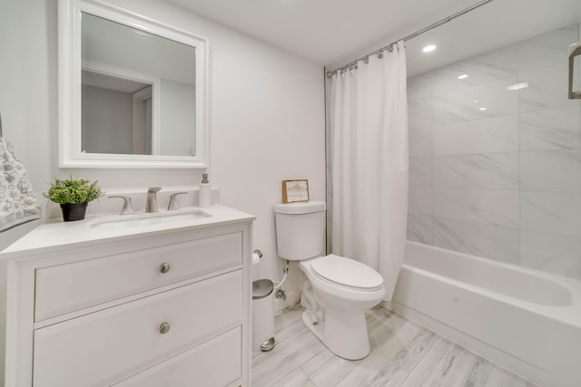 full bathroom featuring wood-type flooring, shower / bath combo, large vanity, and toilet