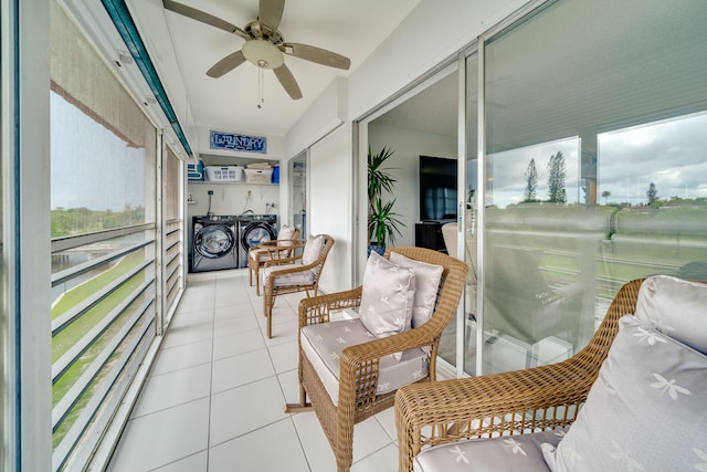 sunroom / solarium with ceiling fan and washing machine and clothes dryer