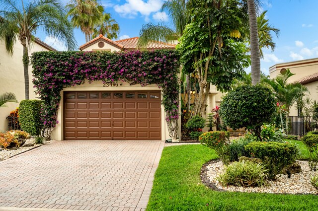 mediterranean / spanish home featuring a garage