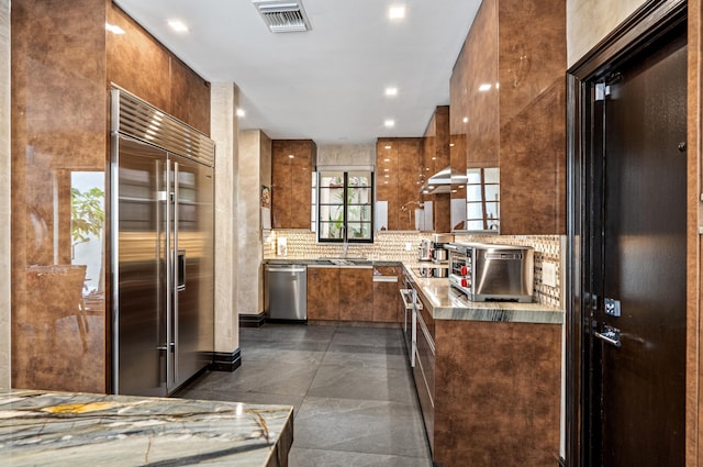 kitchen featuring appliances with stainless steel finishes, backsplash, and sink