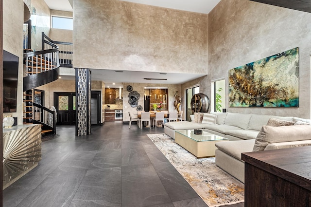 living room featuring a high ceiling