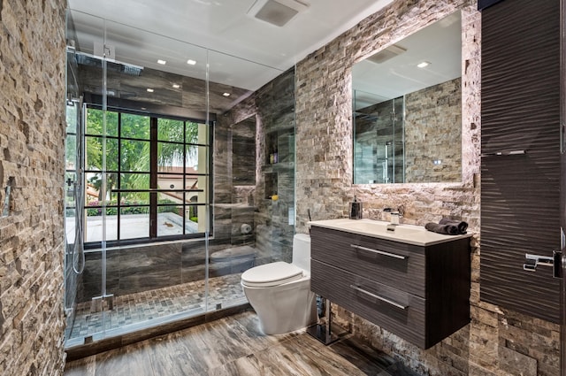 bathroom featuring vanity, toilet, and walk in shower