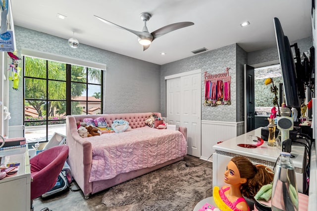 bedroom with ceiling fan and a closet