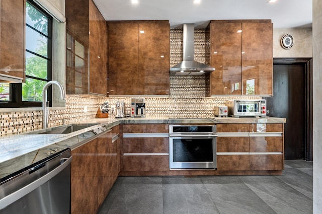 kitchen featuring backsplash, sink, wall chimney range hood, and stainless steel appliances