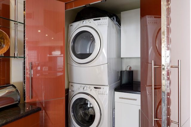 washroom featuring stacked washer / dryer