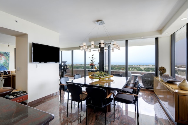 dining room with a notable chandelier and floor to ceiling windows