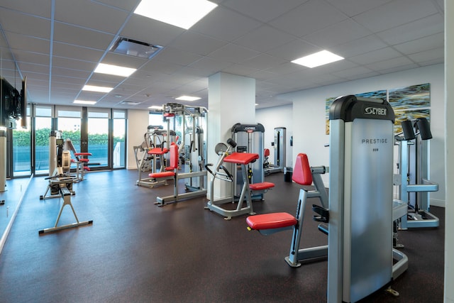 gym with a paneled ceiling