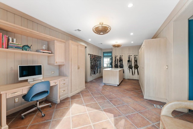 office area featuring built in desk and light tile flooring