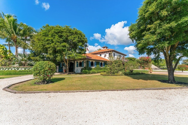 mediterranean / spanish house featuring a front yard