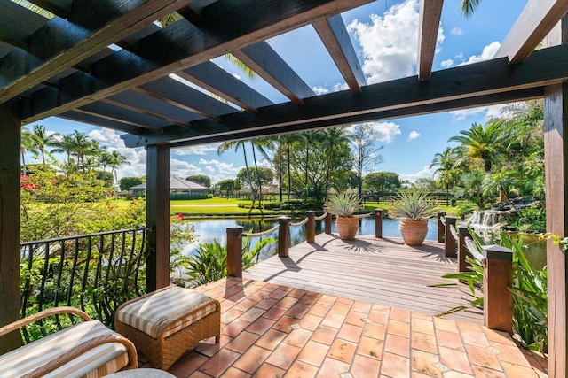 view of terrace featuring a pergola and a water view