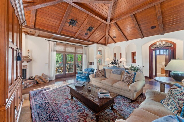 living room with high vaulted ceiling, beam ceiling, an inviting chandelier, and wooden ceiling