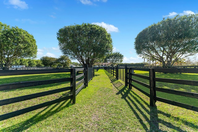 view of gate featuring a yard and a rural view