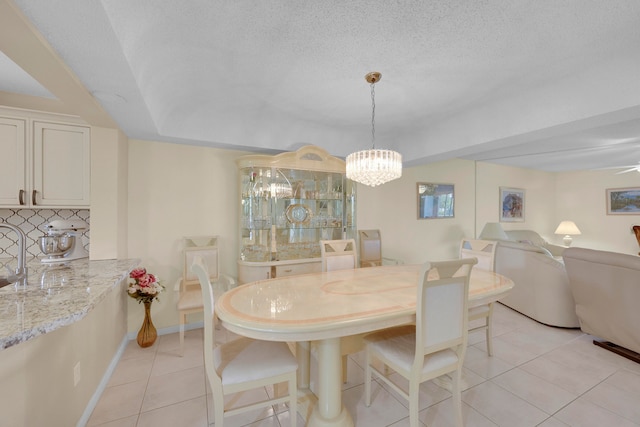 kitchen with decorative backsplash, ceiling fan with notable chandelier, white dishwasher, sink, and stainless steel refrigerator